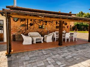 a wooden gazebo with a table and chairs at Il Casale di Lucullo-Holiday Home with Pool and Spa- in Lucignano
