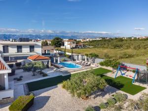 an aerial view of a house with a pool and a playground at Maslina in Vrsi