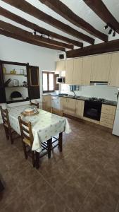 a large kitchen with a table and chairs in it at Spacious Country House for 8 near Olot Remote Work & Nature Escape in Olot