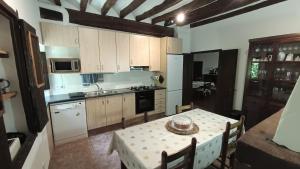 a kitchen with a table with a table cloth on it at Spacious Country House for 8 near Olot Remote Work & Nature Escape in Olot