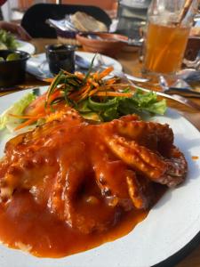 a plate of food with meat and vegetables on a table at Hotel Departamentos Suites in Guanajuato