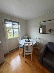 a living room with a table and a couch at Leilighet for opptil 4 personer nær Sola flyplass og Stavanger sentrum in Sola