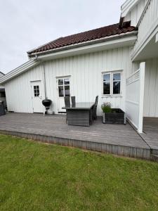 a patio with a table and a grill on a house at Leilighet for opptil 4 personer nær Sola flyplass og Stavanger sentrum in Sola