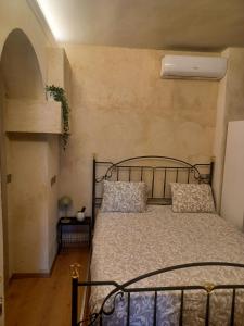 a bedroom with a metal bed with two pillows at LaTorrettaLoano Affittacamere in Loano