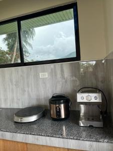 two appliances sitting on a counter in a kitchen at Mystical Hidden Farmhouse in Mahinog