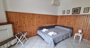 a bedroom with a bed with two towels on it at A casa di Vittorio - tra mare e colline in Montecosaro