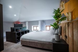 a bedroom with a large bed and a potted plant at Boutique Hotel Solterra - Crikvenica in Crikvenica +167 photos
