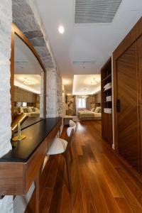 a room with a table and chairs and a stone wall at Hotel Corsaro in Omiš +18 photos