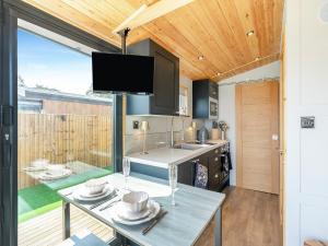 a kitchen with a table with dishes on it at Sky Lark Lodge - Uk49904 in Appley Bridge