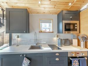 a kitchen with a sink and a counter top at Sky Lark Lodge - Uk49904 in Appley Bridge +13 photos