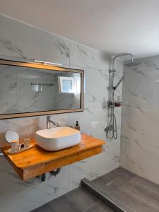 a bathroom with a sink and a mirror at Above the Sea - Sparto in Spartos +15 photos