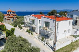 an aerial view of a house with a church at VILLA TOSTi & VILLA JOY in Skala Rachoniou