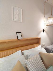 a bedroom with a bed and a clock on the wall at LolaSuite Confort in El Rocío +8 photos