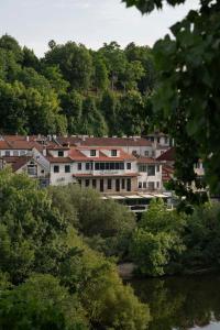 a group of buildings on a hill next to a river at A Casita Clara in Amarante