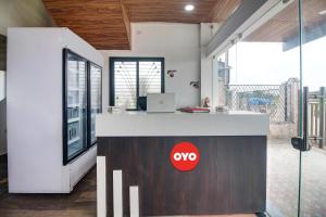 an office with a desk with a laptop on it at Hotel O Goyal Inn in Nagpur