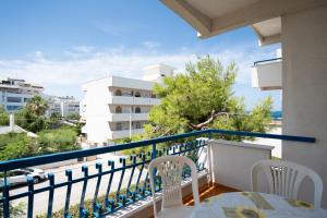 a balcony with a table and chairs and a view at Residence Baia degli Sciti in Torre a Mare