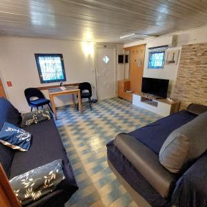 a room with a bed and a couch and a tv at Holiday house in Pula