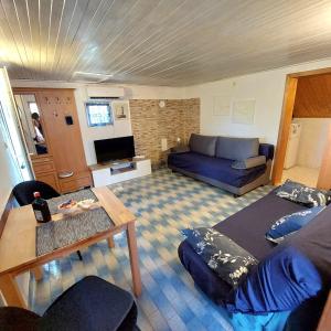a living room with a couch and a table at Holiday house in Pula