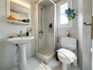 a bathroom with a shower and a toilet and a sink at Matthew's Place in Malia +36 photos