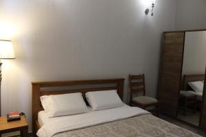 a bedroom with a bed with two white pillows at Strong Five apartment in Sumy