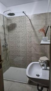 a bathroom with a shower and a sink at Pr' Tekcu in Dekani