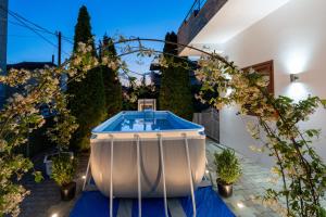 a hot tub in a backyard with plants at Swimming Pool - Marko Studios Berat in Berat