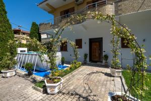 a courtyard with an archway in front of a house at Swimming Pool - Marko Studios Berat in Berat
