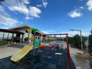 a playground in front of a building with a slide at Absheron Marina in Baku