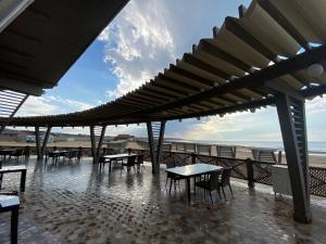 a patio with tables and chairs on the beach at Absheron Marina in Baku