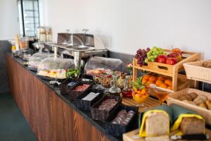 a buffet line with fruit and other foods on it at Green Hotel in Świebodzin