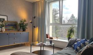 a living room with a couch and a window at Hiiu korter Kärdlas in Kärdla