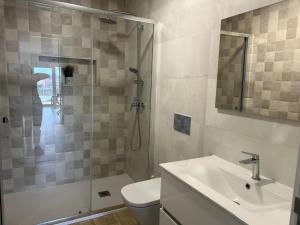 a bathroom with a shower and a toilet and a sink at Quinta da Mainça in Coimbra +24 photos