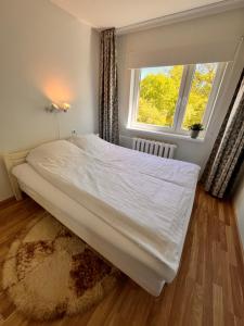 a large bed in a room with a window at Leisi Forest View Apartment in Leisi