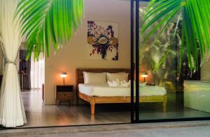 a bedroom with a bed and a glass window at CocoCool Villas in Hinkong