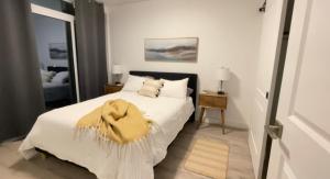 a bedroom with a bed with a yellow blanket on it at Gaslight in Cambridge