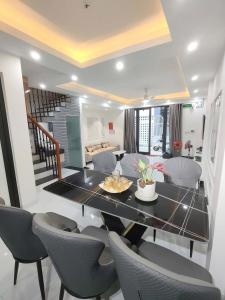 a dining room and living room with a table and chairs at Vinh House Homestay in Thôn Trường Giang +15 photos