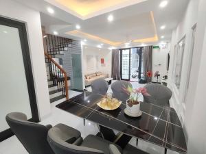 a dining room with a black table and chairs at Vinh House Homestay in Thôn Trường Giang