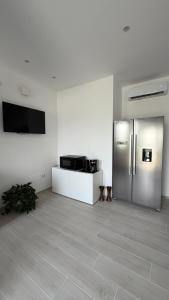a kitchen with a stainless steel refrigerator in a room at Casa Flavia in Lierna