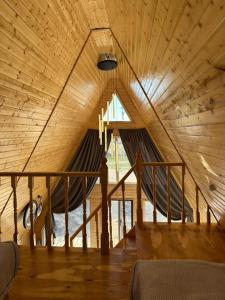 a room with a hammock in a wooden ceiling at Tosor Medet A-frame in Tossor