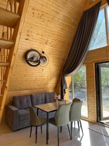 a living room with a couch and a table and chairs at Tosor Medet A-frame in Tossor