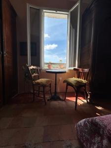 a room with a table and two chairs and a window at Chambre in Riez