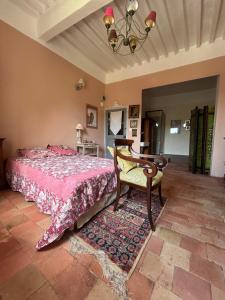 a bedroom with a pink bed and a chair at Chambre in Riez +7 photos
