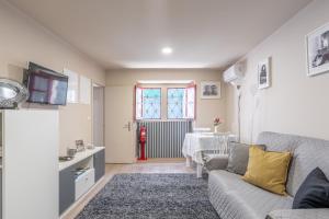 a living room with a couch and a table at CasAmalia 54 in Viana do Castelo