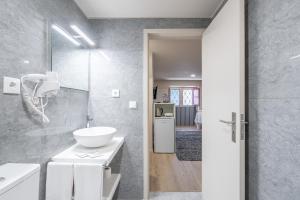 a bathroom with a white sink and a mirror at CasAmalia 54 in Viana do Castelo +43 photos