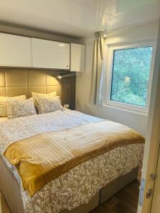 a bedroom with a large bed with a window at Garden Lodge Obervellach in Obervellach