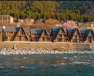 a row of houses on the shore of a river at Asal Riverside Pahalgam in Pahalgām