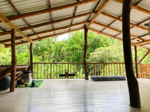 a view of a porch with a wooden deck at Tres Corazones in Carrillo