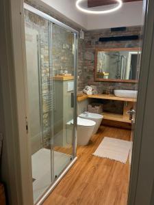 a bathroom with a glass shower and a toilet at A un passo dal Collio in Mossa +17 photos