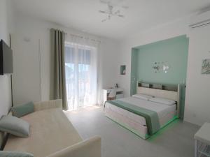 a bedroom with a bed and a couch at Le Cromie di Amelie in Ceglie Messapica