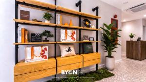 a wooden shelf with books on it in a room at The Tapir Puchong by BYON Premium Suites & Hotels in Puchong